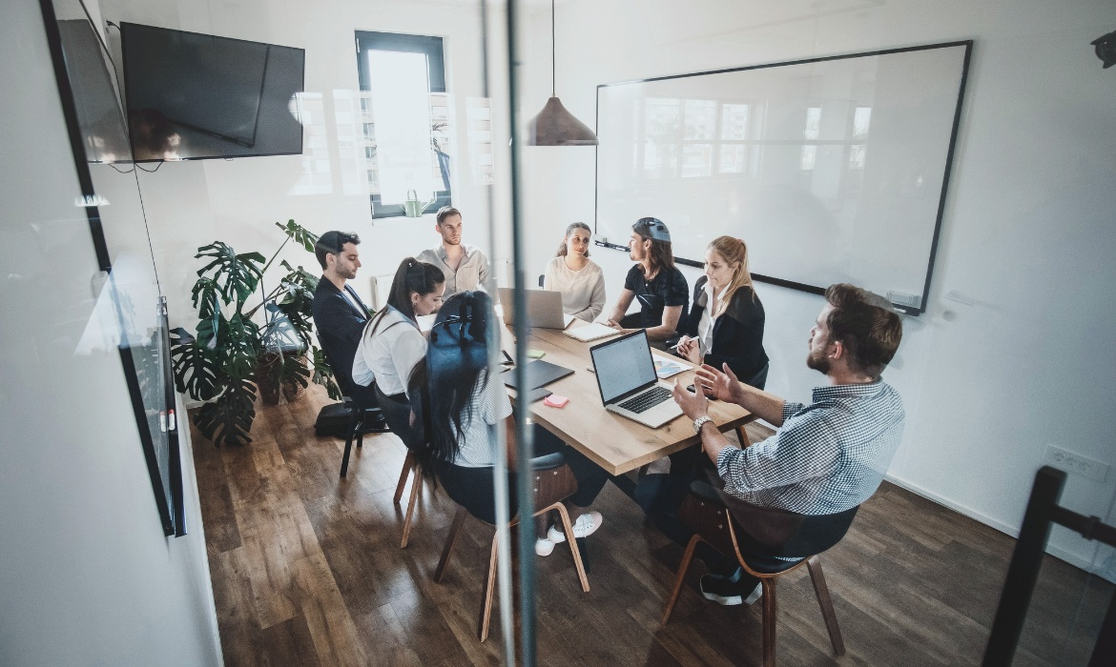 Collaborative business team meeting around a table in a modern office